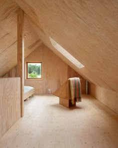 an attic bedroom with wooden walls and flooring