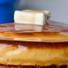 a stack of pancakes covered in syrup and butter