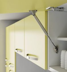 the door handle is attached to the cupboards in the room that has yellow and white walls