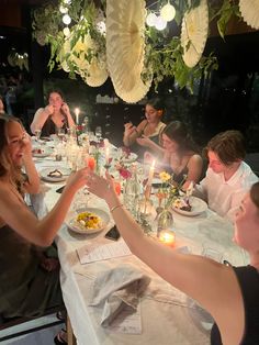 a group of people sitting around a dinner table