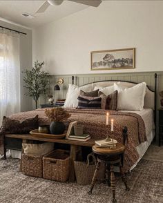 a bedroom with a large bed and two wicker baskets on the end tables in front of it