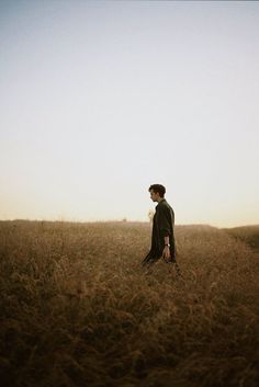 a man standing in the middle of a field