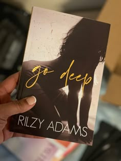 a person holding up a book with the title'go deep'in front of them