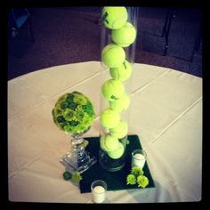 a vase filled with tennis balls sitting on top of a table