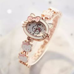 a hello kitty watch is shown on a marble surface