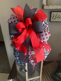 a lantern with red and black bows on it