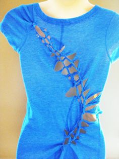 a woman's blue shirt with an intricate design on it