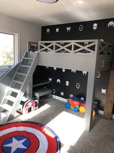 a bedroom with a bunk bed, ladder and wall decals on the walls is shown