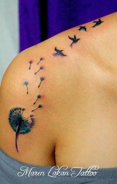 a woman with a tattoo on her shoulder has a dandelion blowing in the wind