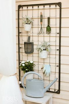 there is a garden rack with gardening tools on it