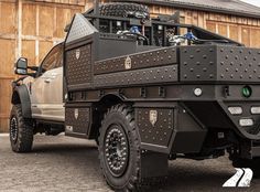 an off - road vehicle parked in front of a wooden building