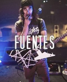 a man standing next to a guitar on top of a stage with the words fuenties above him