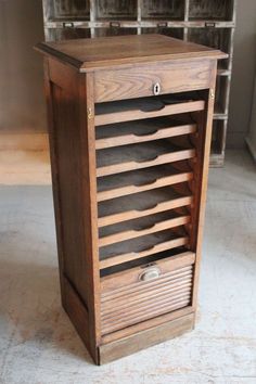 an old wooden cabinet with many drawers on the front and bottom shelves in different sizes