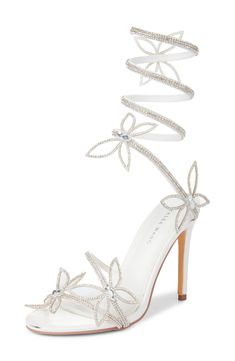 Butterfly embellishments enhance the dreamy effect of a lofty sandal with straps covered in shimmering crystals. 4 1/4" heel (size 8.5) Wraparound ankle strap Synthetic upper, lining and sole Imported Asian Owned/Founded White Heels With Butterflies, Silver Butterfly Heels, White Prom Shoes, Quince Heels, Sandals Summer Heels, Laced Heels, Grad Shoes, Dreamy Effect, Glittery Heels