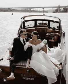 a man and woman sitting on the back of a boat