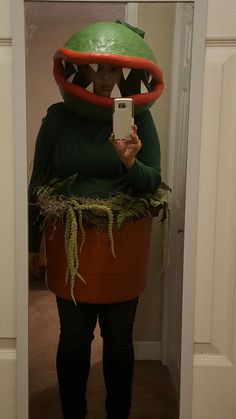 a person in a plant costume taking a selfie