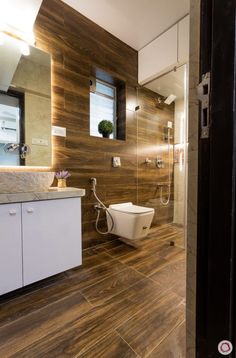 a modern bathroom with wooden flooring and walls