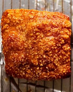 a square piece of bread sitting on top of a metal rack