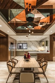 a dining room with a wooden table surrounded by chairs