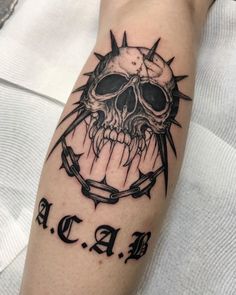 a person with a skull and anchor tattoo on their arm