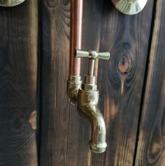 the faucet is attached to the wooden wall