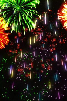 fireworks are lit up in the night sky with bright colors and sparkles on them