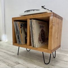 a record player sitting on top of a wooden stand