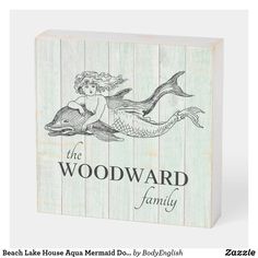 a wooden block with the words woodward family on it and an image of a mermaid swimming