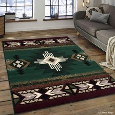 a living room with a couch and rugs on the wooden floor next to a window