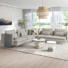 a modern living room with white furniture and wood flooring