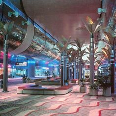 an empty lobby with palm trees and lights