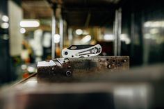 a pair of scissors sitting on top of a piece of metal