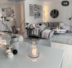 a living room filled with lots of furniture and candles on top of the coffee table