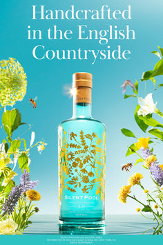 a blue bottle with yellow flowers on it and the words, handcrafted in the english countryside