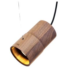 a wooden light hanging from a black cord