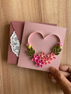 a handmade heart shaped card with flowers on it