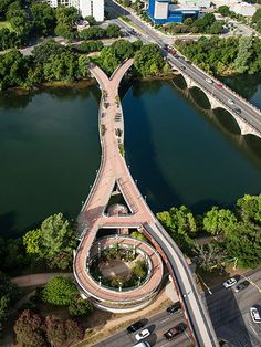 an aerial view of a bridge over a body of water with cars driving on it