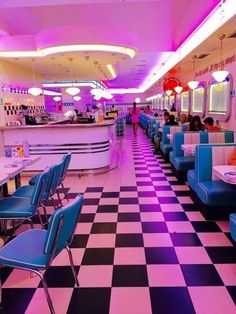 a diner with checkered flooring and blue chairs