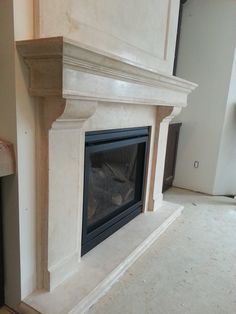 an empty room with a fireplace in the middle and no one around it on the floor