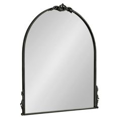 an ornate arched mirror on a white background with black trimmings and scrolls around the edges