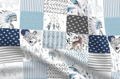 an american flag quilt with wolfs and stars on the front, in blue and white