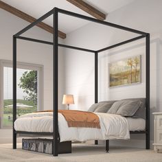 a bedroom with a four poster bed and white walls