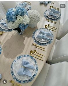 the table is set with blue and white flowers