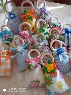 a bunch of small pieces of fabric with flowers and bows on them sitting on a table