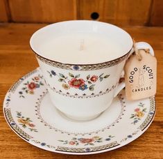 a cup and saucer with a candle on it