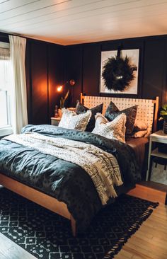 a large bed sitting in a bedroom next to a window