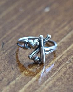 a silver ring sitting on top of a wooden table