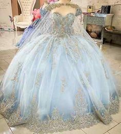 a blue ball gown on display in a room with teddy bears and stuffed animals behind it