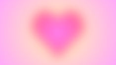 a blurry image of a pink heart