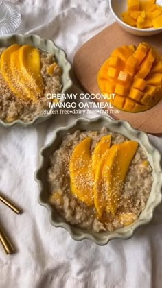 two bowls filled with oatmeal topped with mango slices